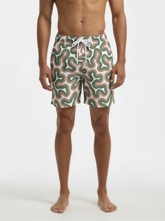 swim-trunk-darwin-by-copala-beach-drawstring-swim-short-in-white-green-and-peach-abstract-wave-print-on-model-front-view